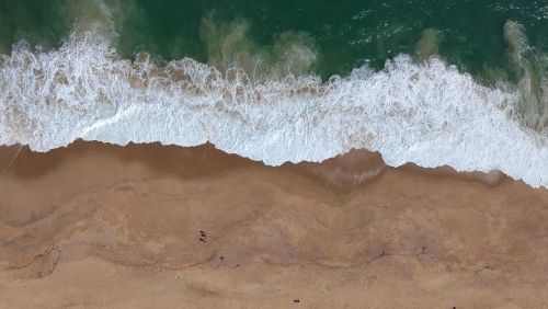 Free Stunning aerial shot of waves crashing on Algarrobo Beach, Chile. Stock Photo