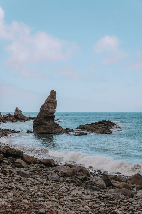 Free Explore the rugged beauty of Hermigua Beach with its stunning sea stack and rocky coastline. Stock Photo