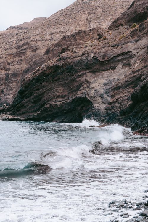 Free Discover the rugged volcanic cliffs and crashing waves of Hermigua, Canary Islands, Spain. Stock Photo