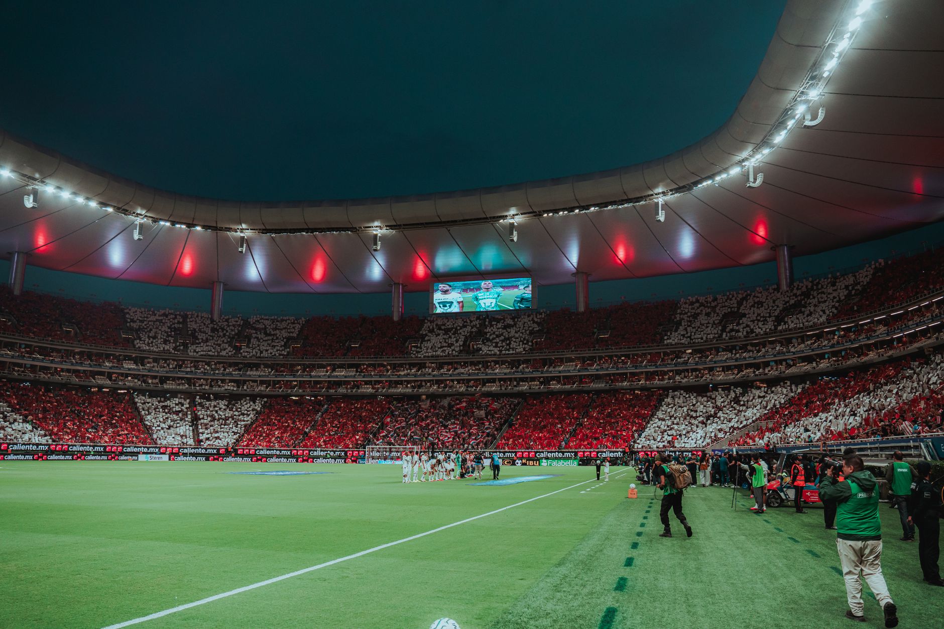 packed Estadio Azteca in Mexico City glowing under evening lights before a World Cup match