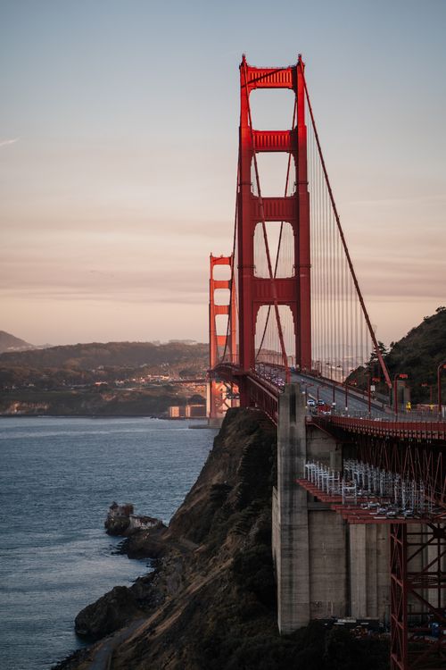 Free Scenic view of Golden Gate Bridge during sunset in San Francisco, featuring a warm autumn sky. Stock Photo