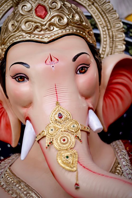 Free Close-up of an intricately decorated Ganesh statue with gold ornaments. Stock Photo