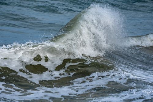 Free A dramatic capture of a powerful wave crashing with seafoam off the coast of Cullera, Spain. Stock Photo