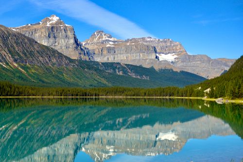 Free Stunning reflection of Canadian Rockies in a clear lake at Banff National Park, Alberta. Stock Photo