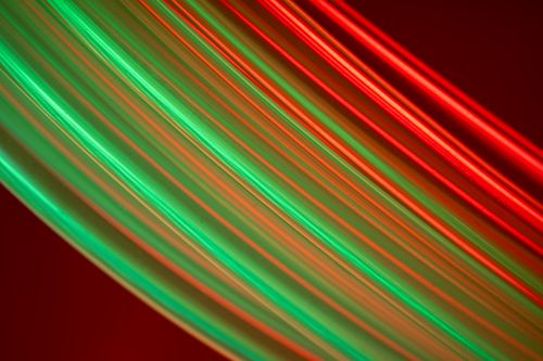 Free Dynamic red and green light trails forming abstract shapes and vibrant movements. Stock Photo