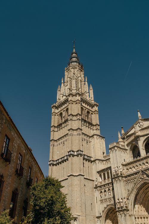 Free View of Toledo Cathedral's bell tower against a clear blue sky in Spain. Stock Photo