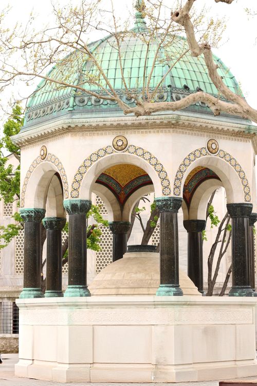 Free A beautifully decorated gazebo with mosaic tiles and arched columns in an outdoor setting. Stock Photo