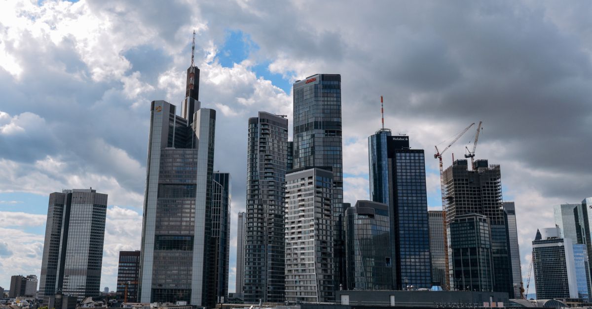 View of Frankfurt skyline featuring modern skyscrapers under a cloudy sky.