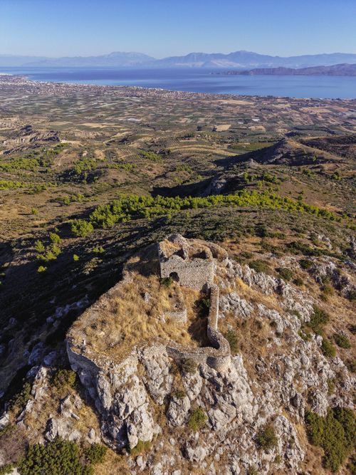 Free Aerial view of ancient ruins in Greece with stunning coastal views and rolling hills. Stock Photo
