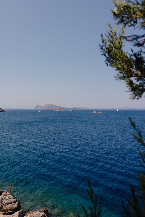 Free A breathtaking view of the clear blue waters and distant islands off the Greek coast under a sunny sky. Stock Photo