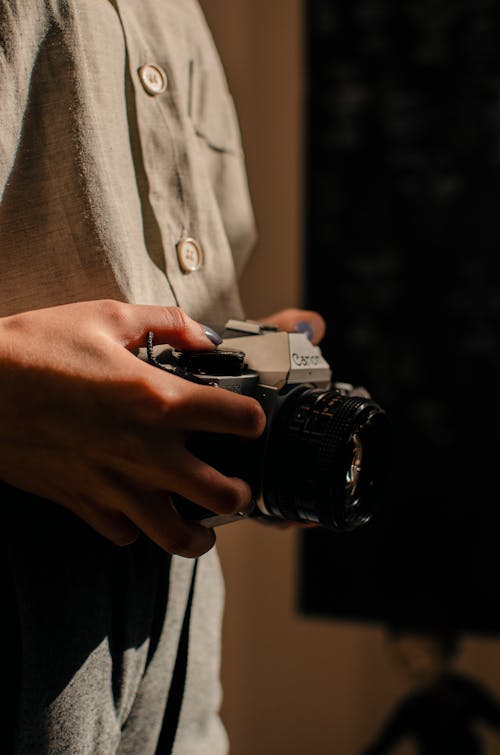 Person Holding Black and Silver Dslr Camera