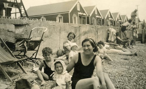 Grayscale Photo Of Group Of People Sitting 