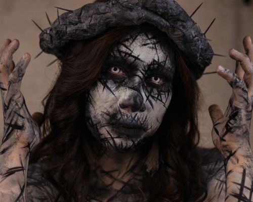 Free Artistic portrait featuring a person with face paint and a thorned crown in Mexico City. Stock Photo