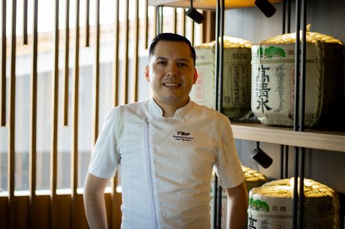 Free A professional chef posing in a contemporary restaurant setting with traditional decor elements. Stock Photo
