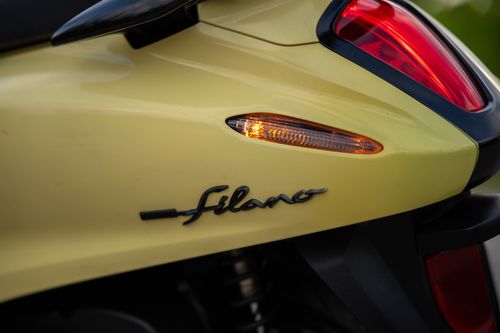 Free Detailed close-up of yellow scooter's rear light and Filano logo, showcasing its design. Stock Photo