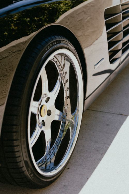 Free Detailed view of a shiny alloy wheel on a luxury car, showcasing design and style. Stock Photo