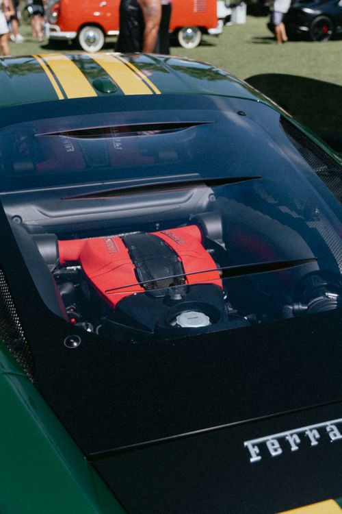 Free Detailed view of a sports car engine with vibrant red accents displayed under glass. Stock Photo