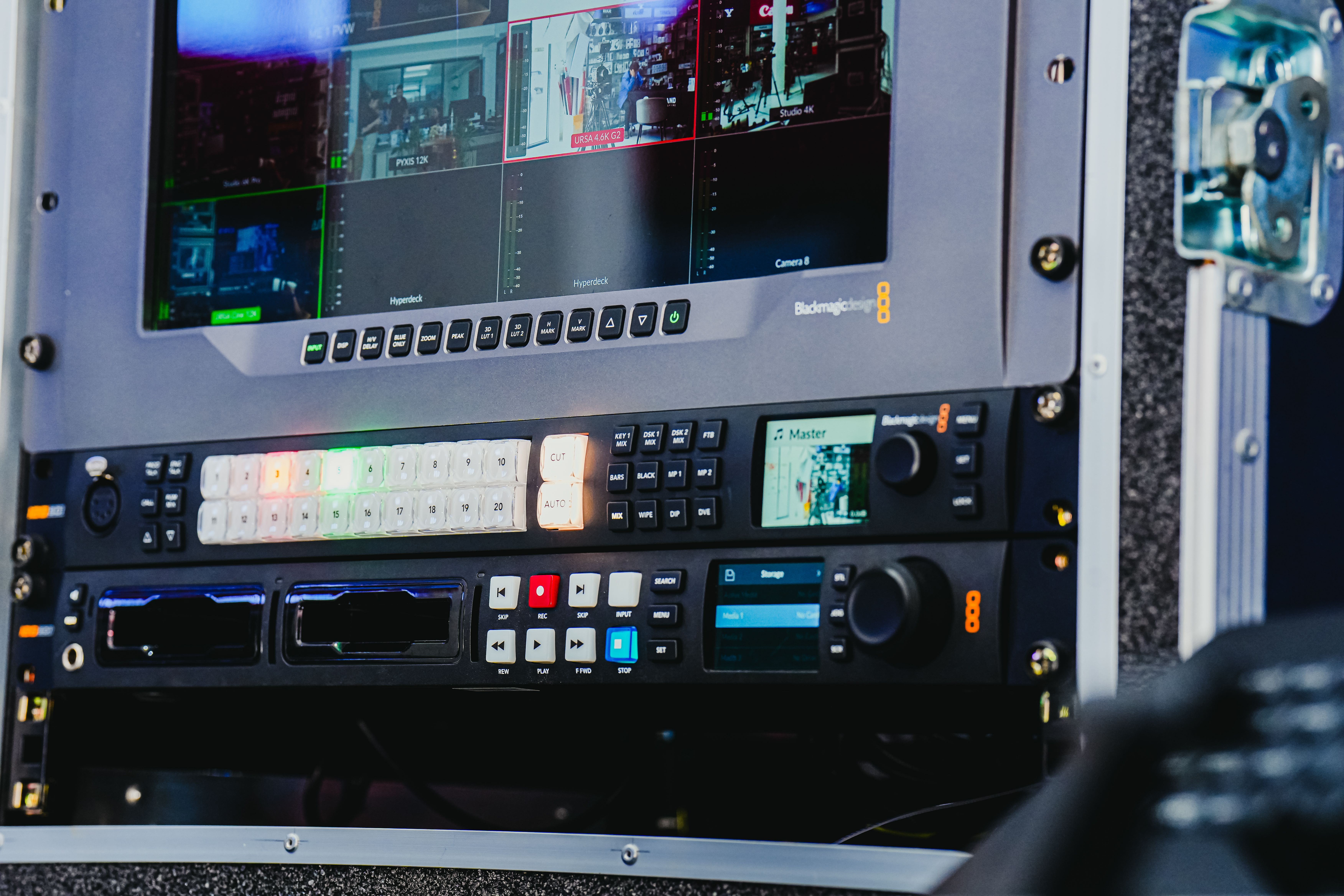 Close-up of advanced video editing equipment featuring multiple screens and control panels.