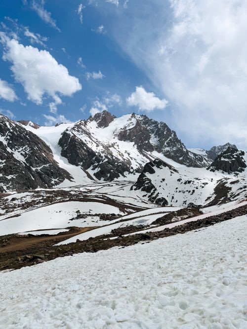 Free Stunning view of snow-covered mountains under a vibrant blue sky in Almaty, Kazakhstan. Stock Photo