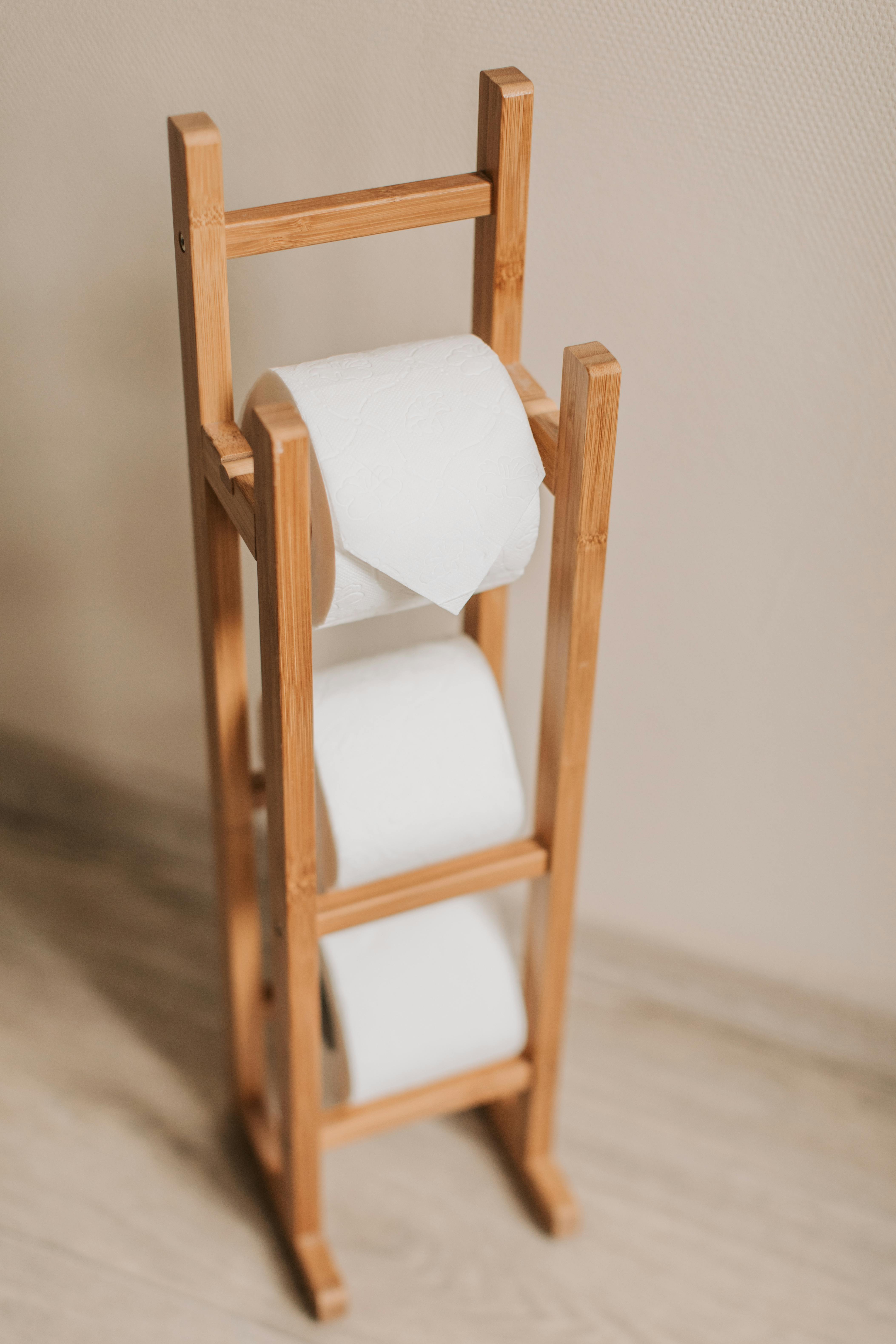 White Toilet Paper Rolls on Brown Wooden Rack · Free Stock Photo