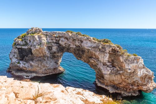 Free Explore the stunning Es Pontas rock arch on the Mallorca coast with turquoise waters. Stock Photo