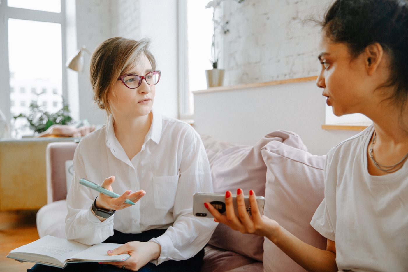 Adult patient discussing trauma-related symptoms with a mental health professional during a supportive counseling session
