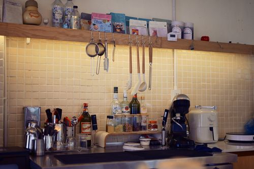 Free A warm, inviting kitchen counter with various utensils and a coffee machine, perfect for a homey feel. Stock Photo