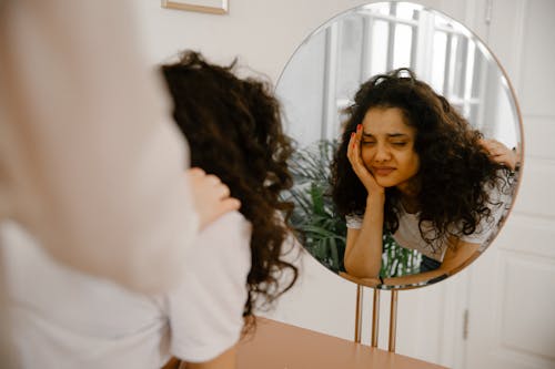 Free Reflection of Sad Woman in Mirror Stock Photo