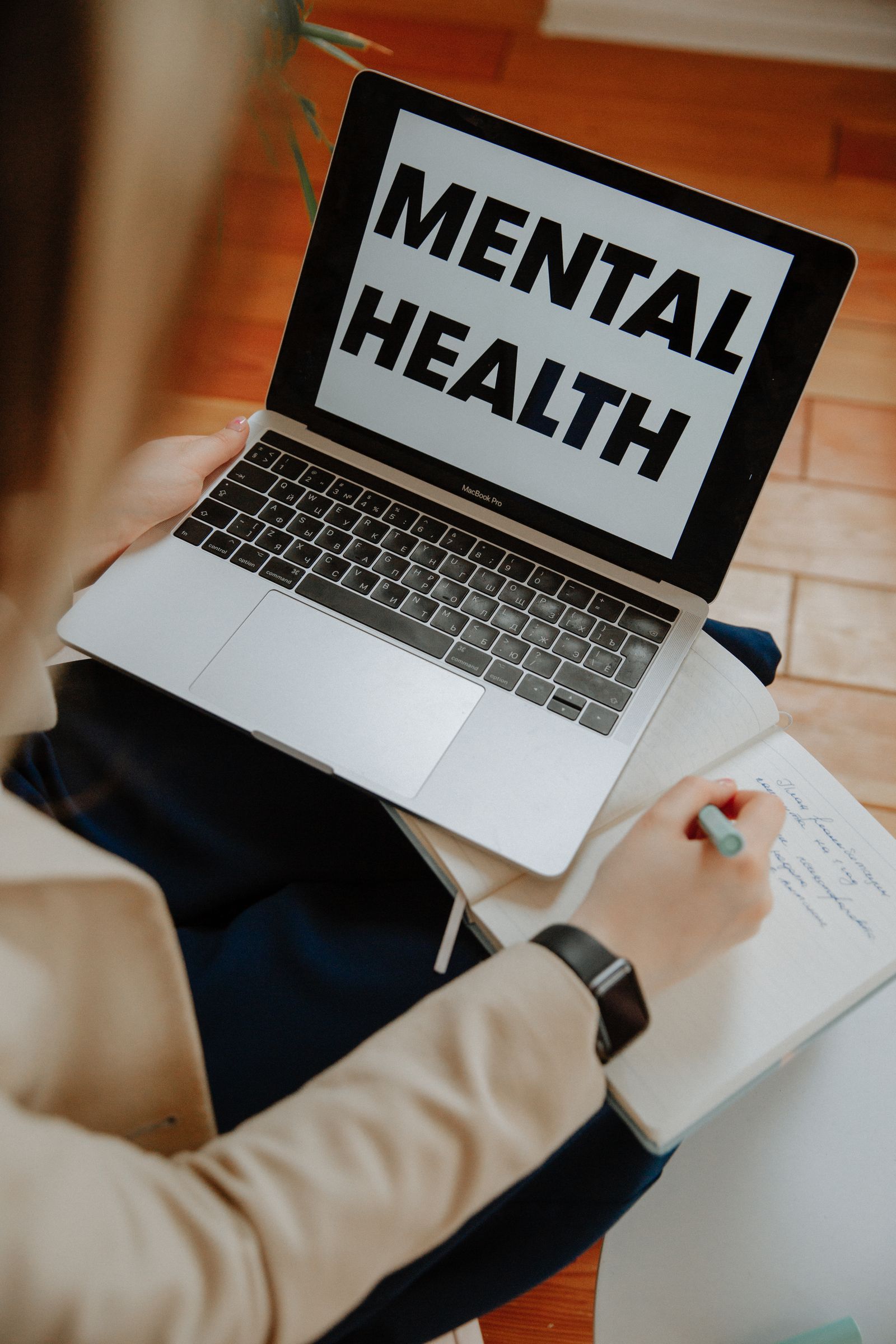 Woman participating in an online mental health session using a laptop