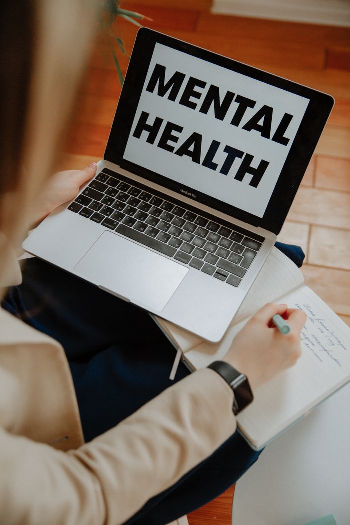 Woman participating in an online counseling session using a laptop