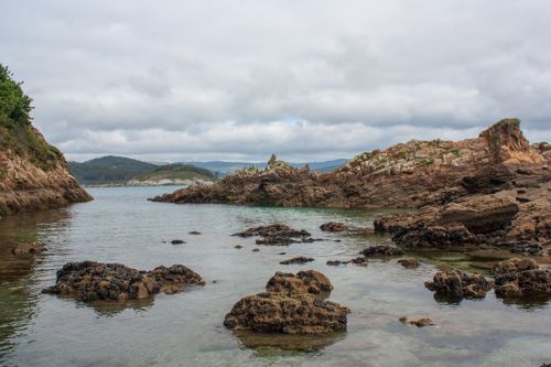 Free Scenic view of rocky coastline and calm sea in Galicia, Spain. Stock Photo