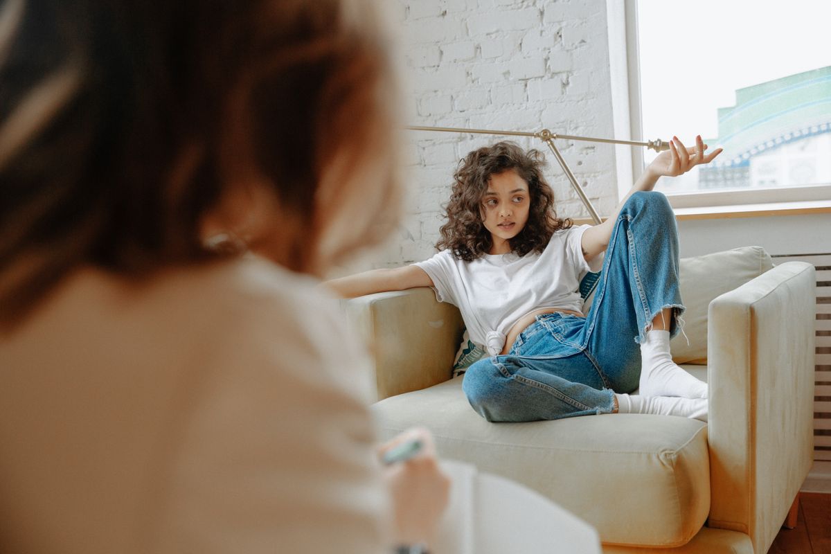 Supportive one-to-one conversation with a young person in a calm, professional setting