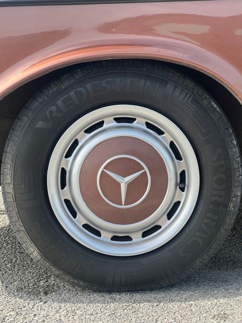 Free Close-up shot of a vintage car wheel, highlighting the Mercedes emblem and tire tread pattern. Stock Photo