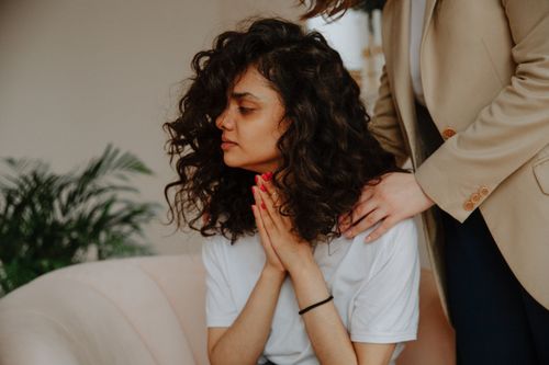 Free A young woman receives emotional support during a therapy session indoors. Stock Photo