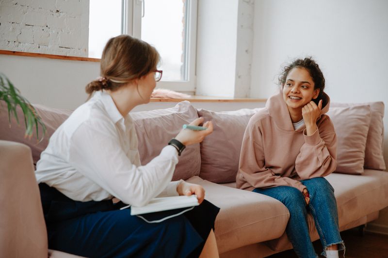 A counsellor and client talking in a relaxed one to one session