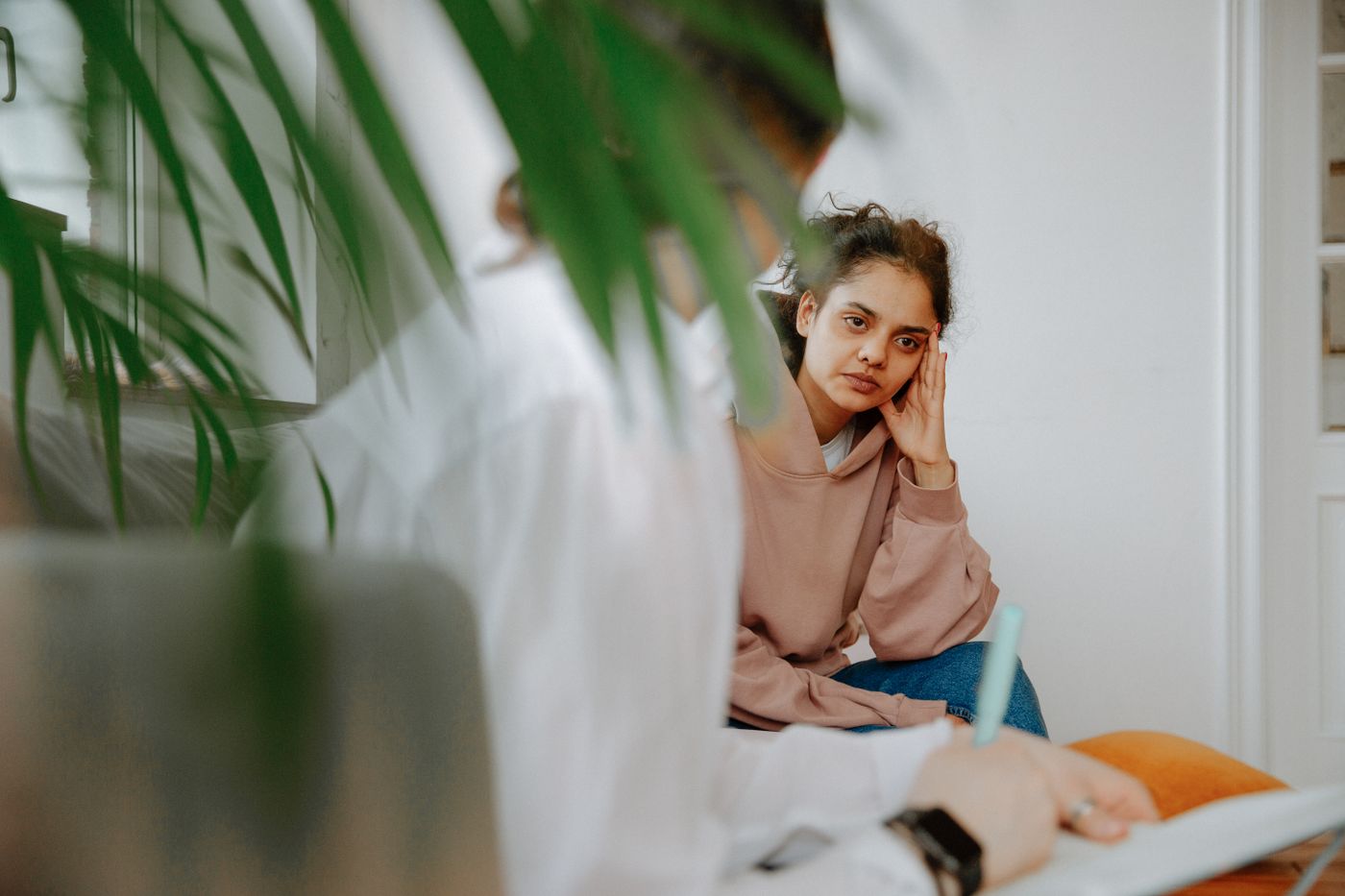 Adult discussing mental health concerns with a therapist during a professional consultation