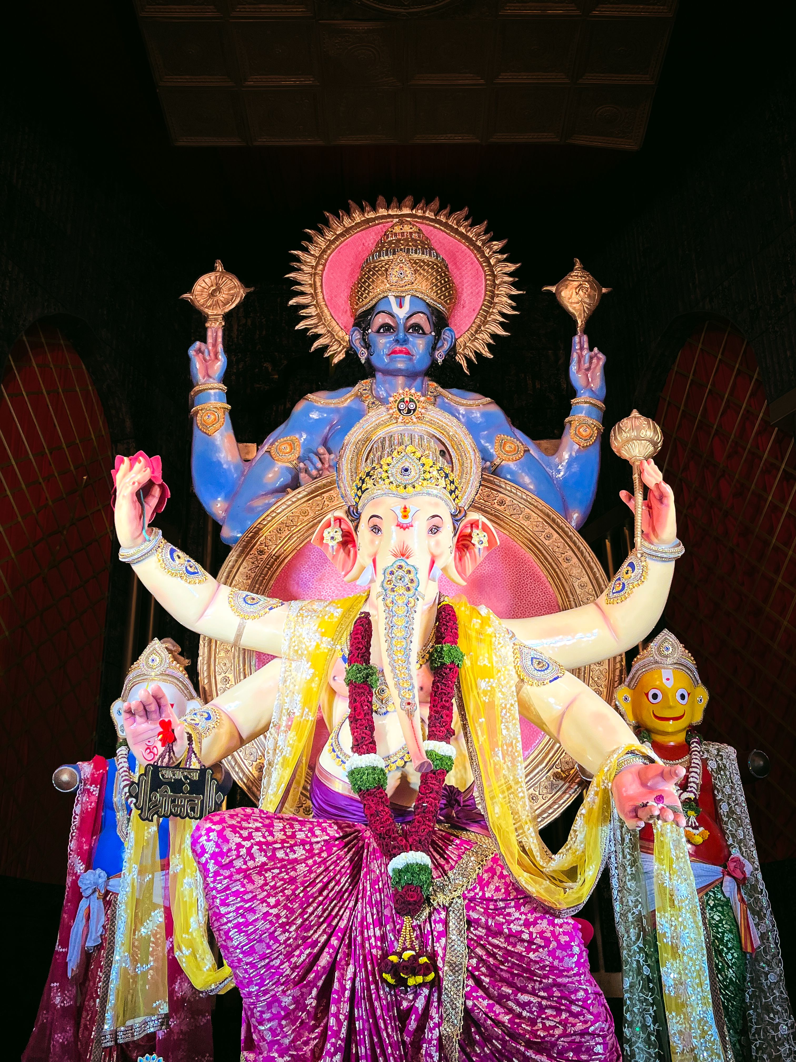 Colorful Hindu deities in a temple setting capturing divine artistry.
