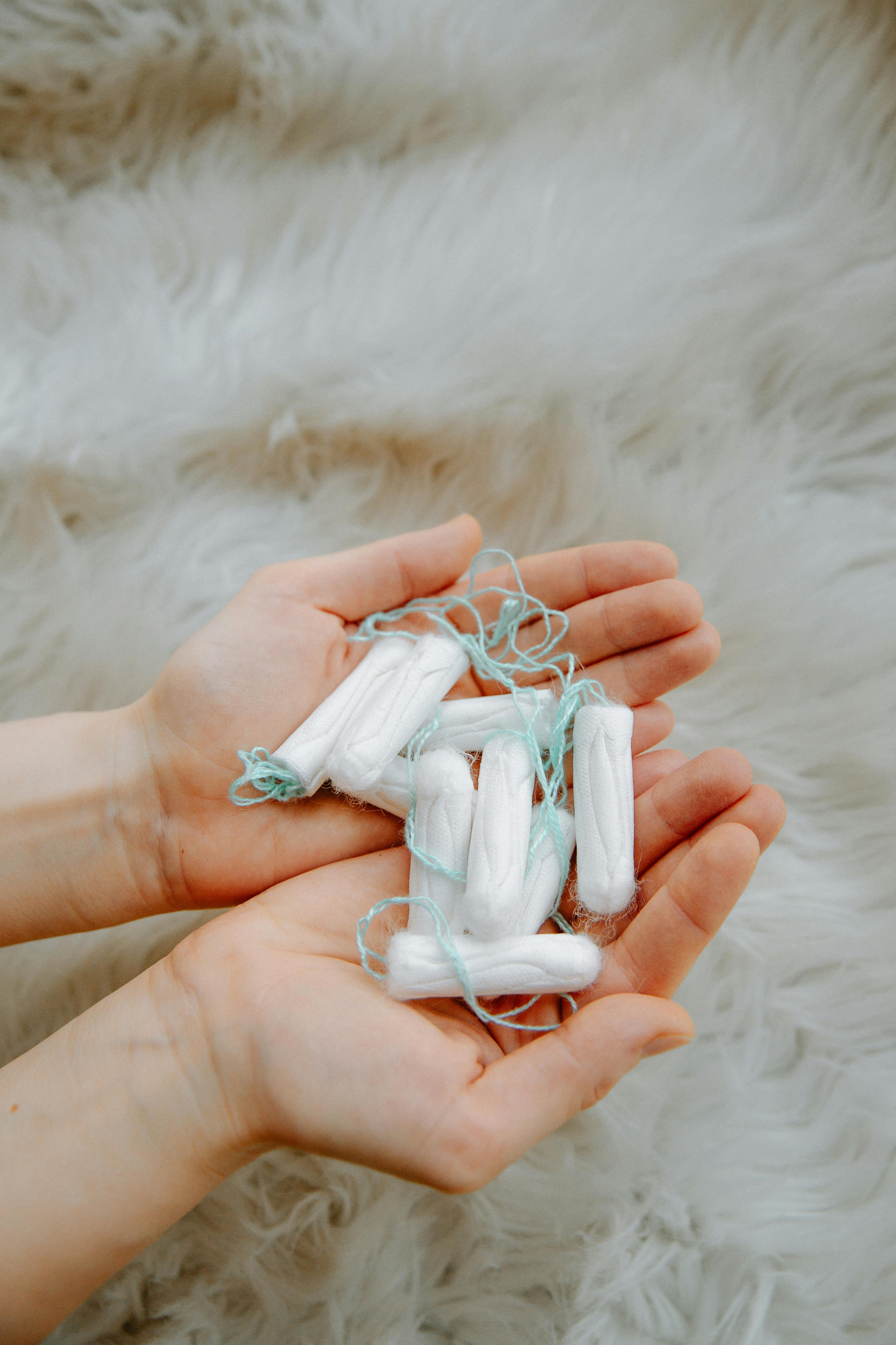 Person Holding Tampons · Free Stock Photo