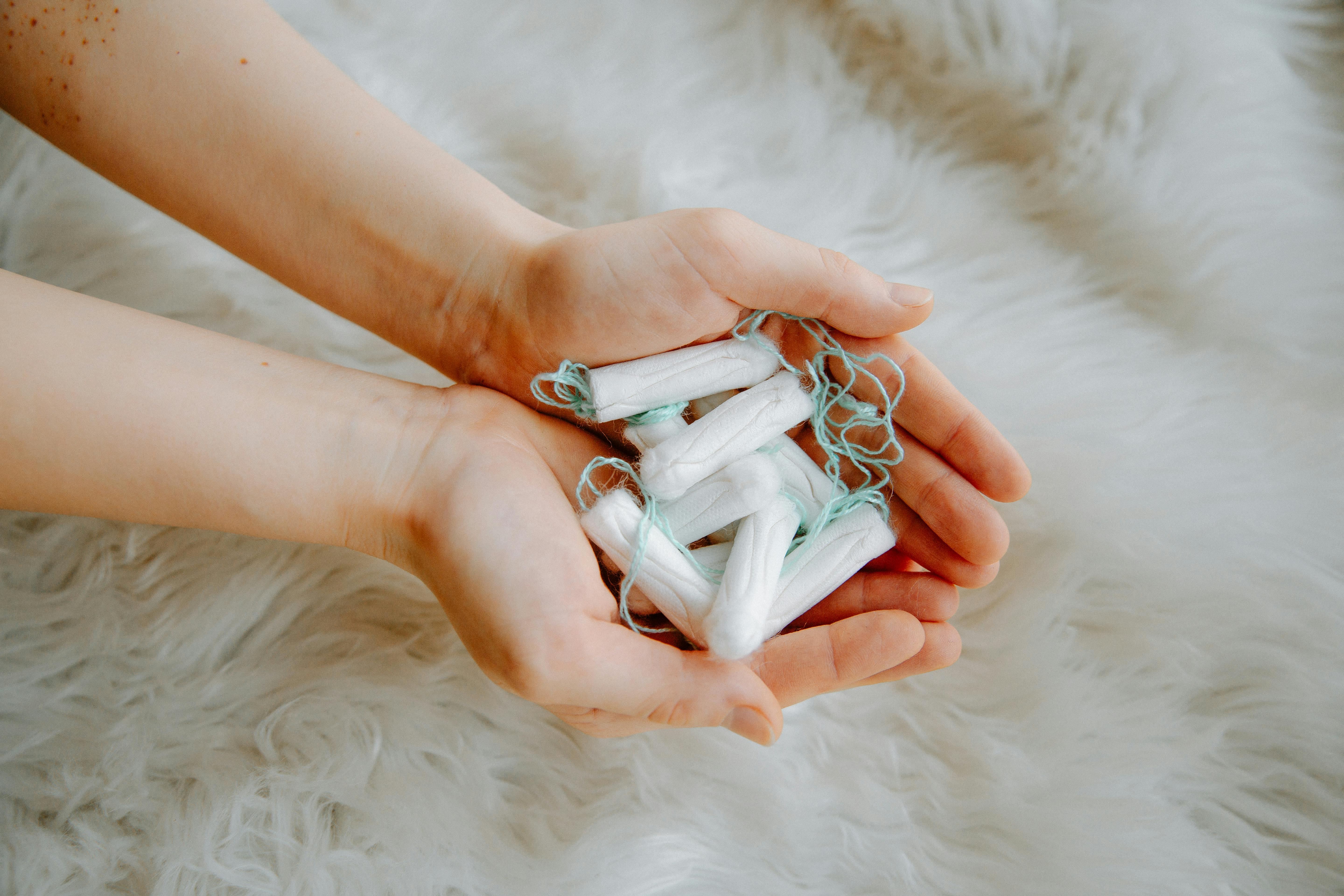 Person Holding Tampons · Free Stock Photo