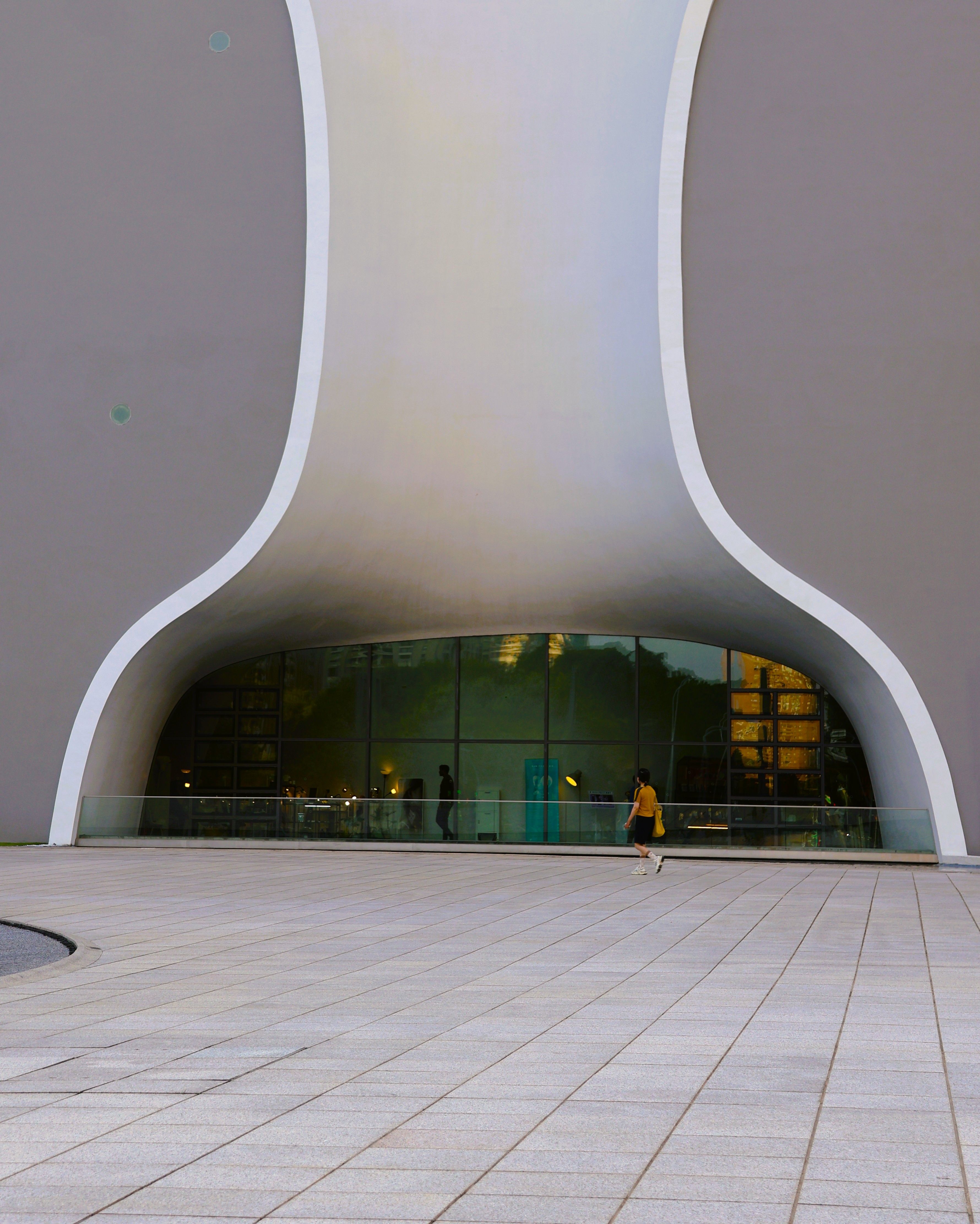 Elegant modern architecture in Taichung, Taiwan, showcasing unique curves and glass facade.