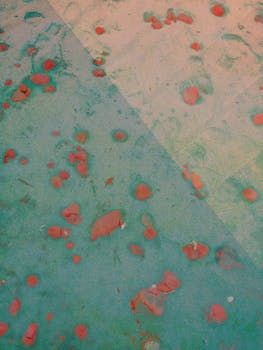 Top view of acrylic abstract artwork with contrast colors divided by straight vertical line and small red stains on surface