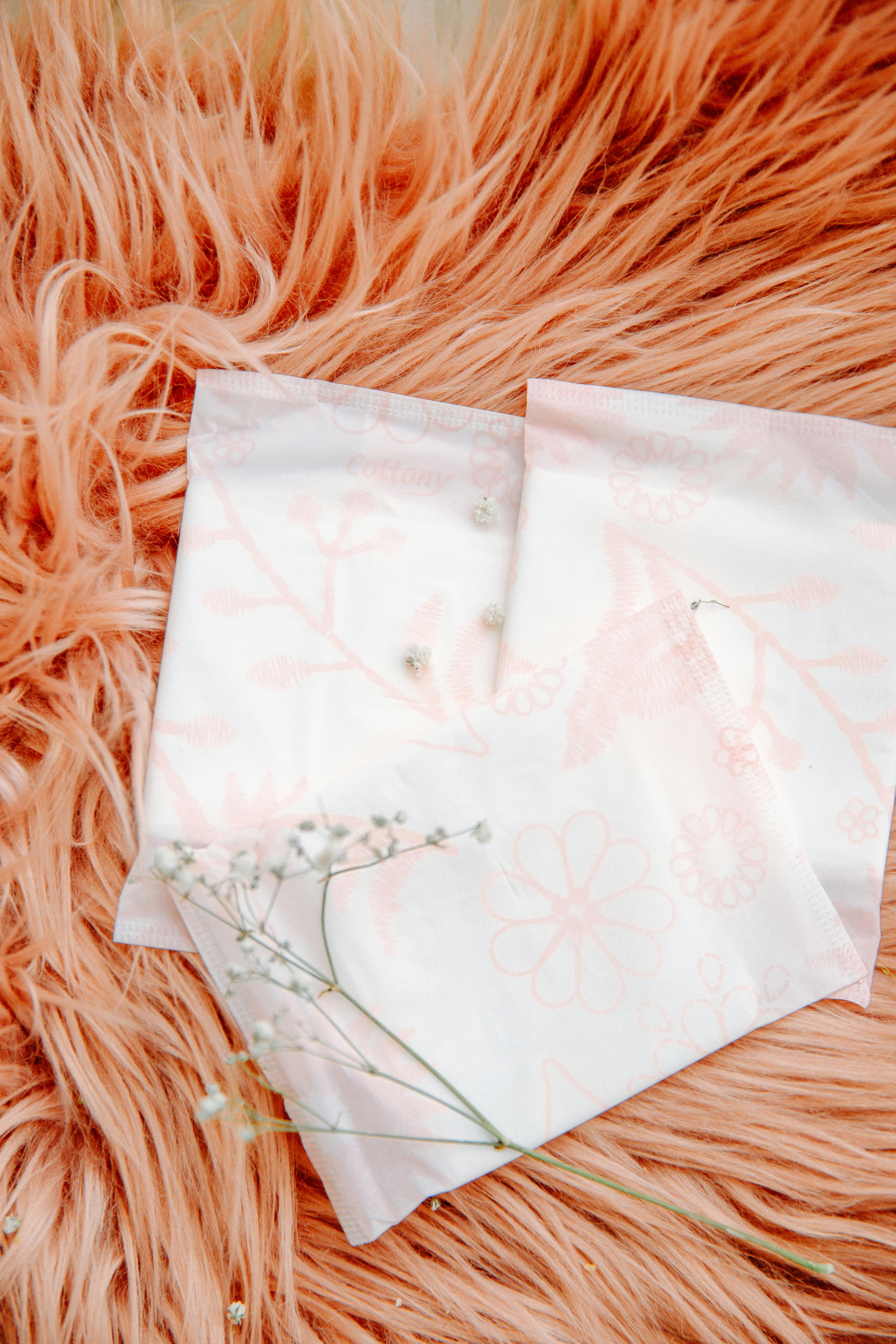 Sanitary pads resting on soft fur, highlighting feminine hygiene concepts.