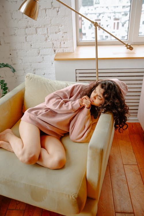 Woman Curled Up in Armchair