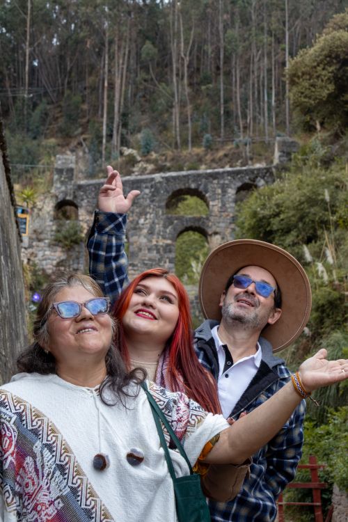 Free A joyful group of adults exploring a scenic outdoor area with historical architecture. Stock Photo