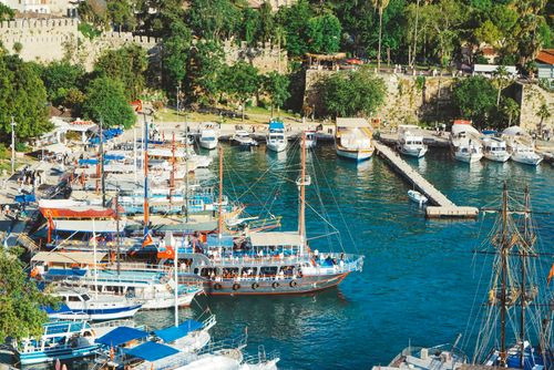 Free A vibrant Mediterranean harbor filled with boats and yachts on a sunny day. Stock Photo