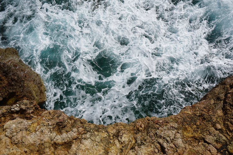 Water Waves Hitting Brown Rock