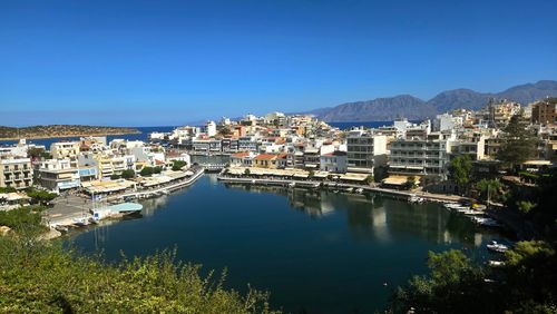 Free Beautiful panoramic view of Agios Nikolaos harbor in Crete, Greece, under a clear blue sky. Stock Photo