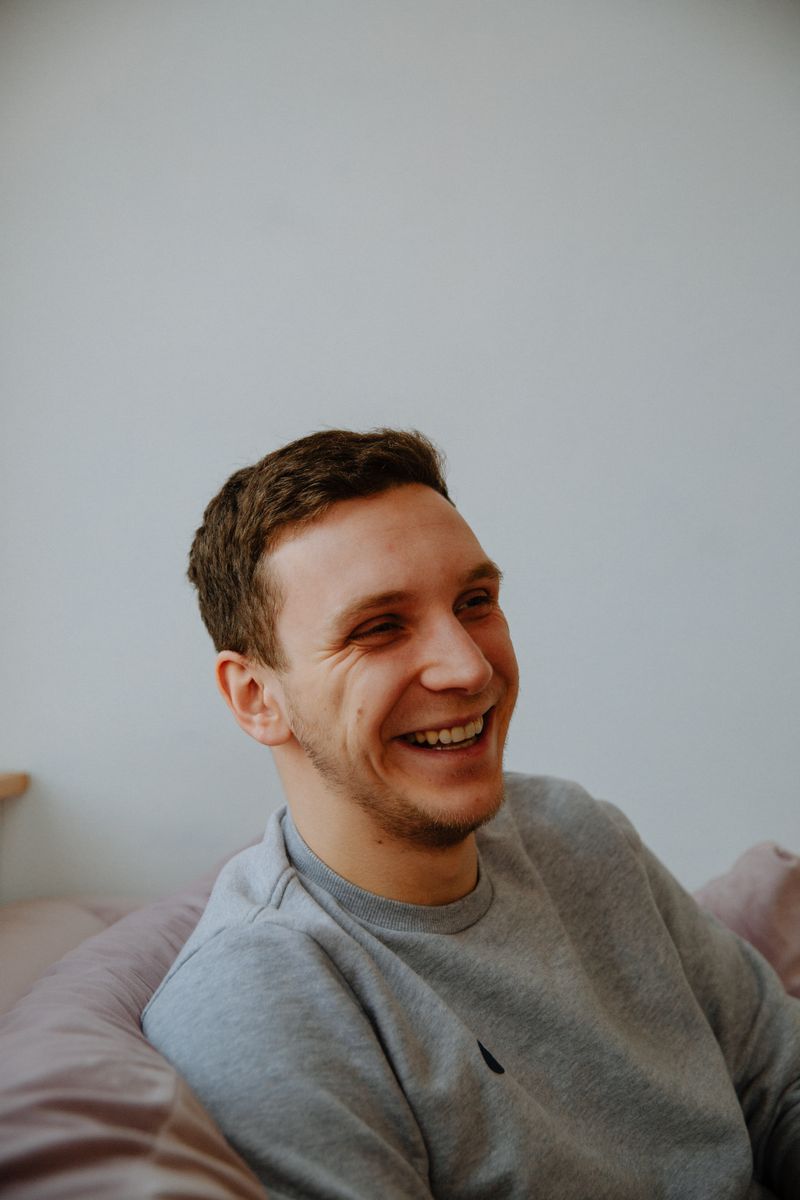 Person sitting quietly with cup of tea allowing themselves to feel emotions