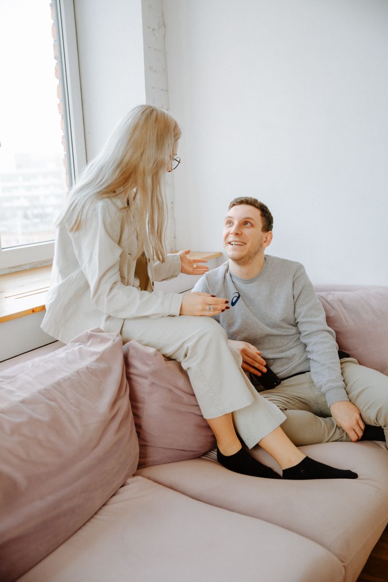 A couple having a warm conversation together on a sofa at home