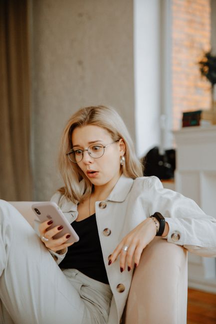 person reading news smartphone skeptical